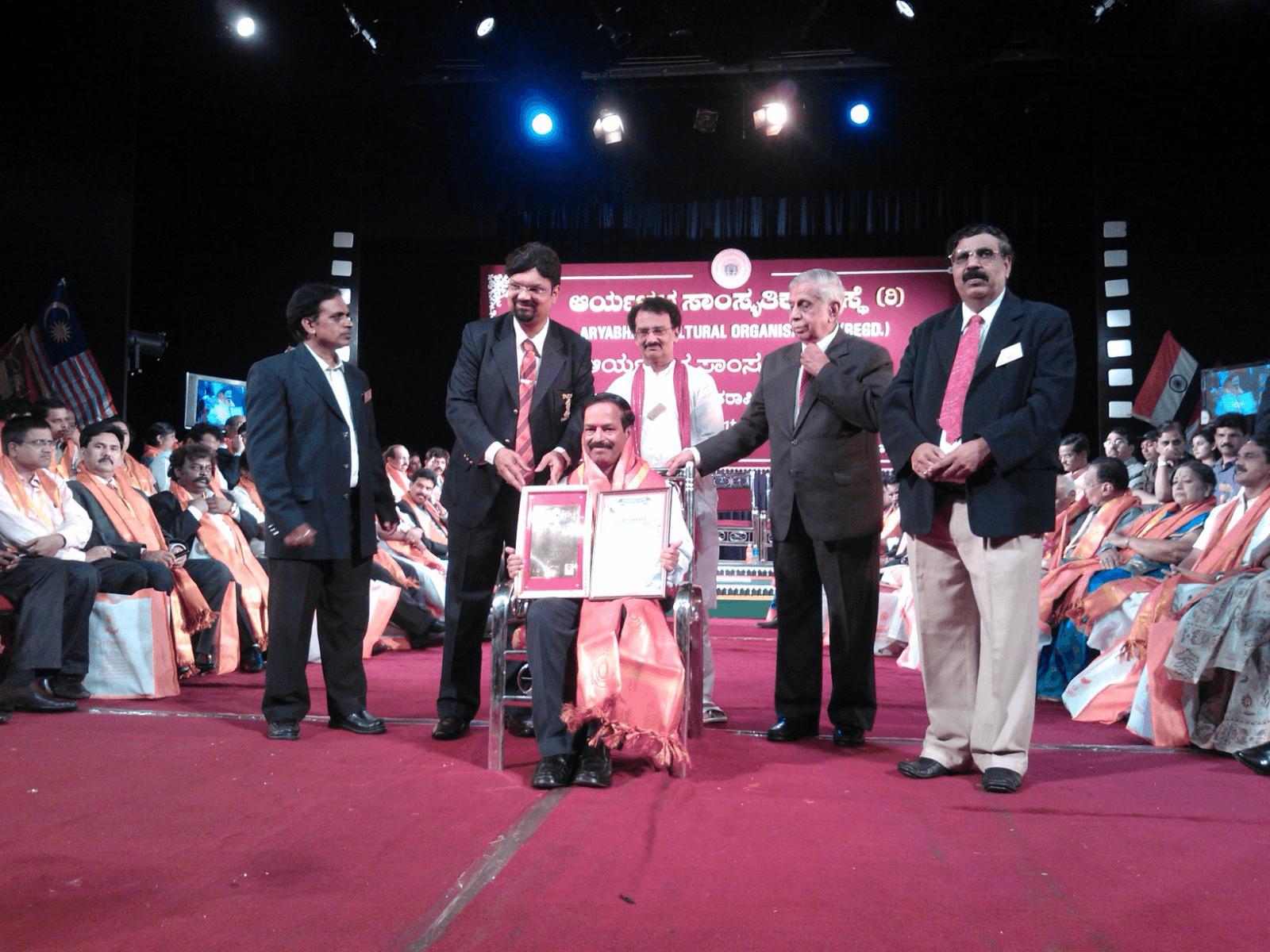 Nachiketha Manovikasa Kendra being honoured on stage at the Aryabhata Cultural Organisation awards